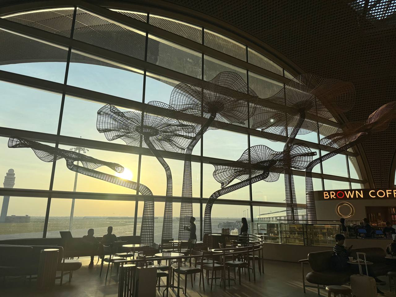 Sunset light through an airport cafe with sculptural decorations