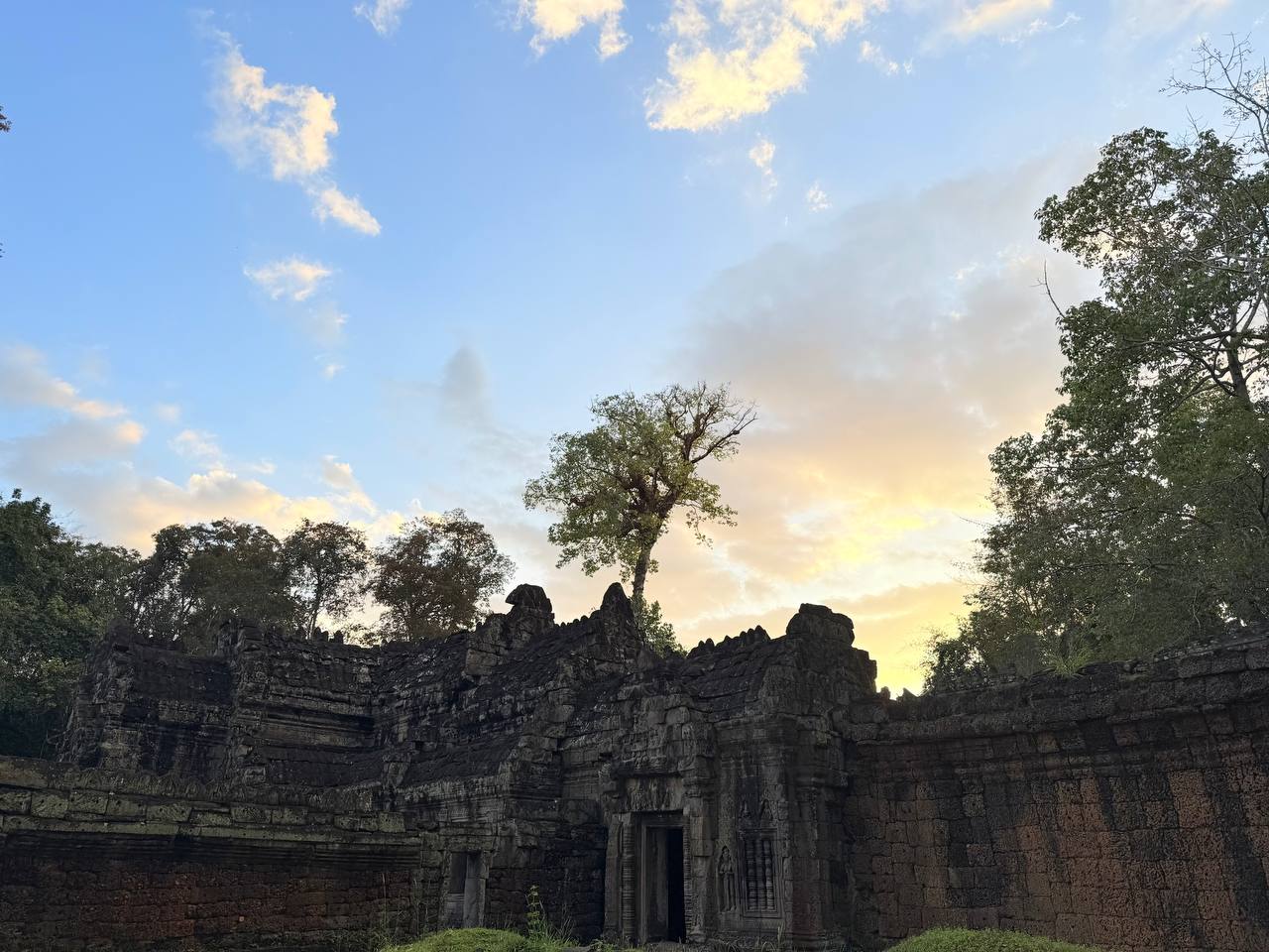 Ancient stone temple ruins beneath a colorful evening sky