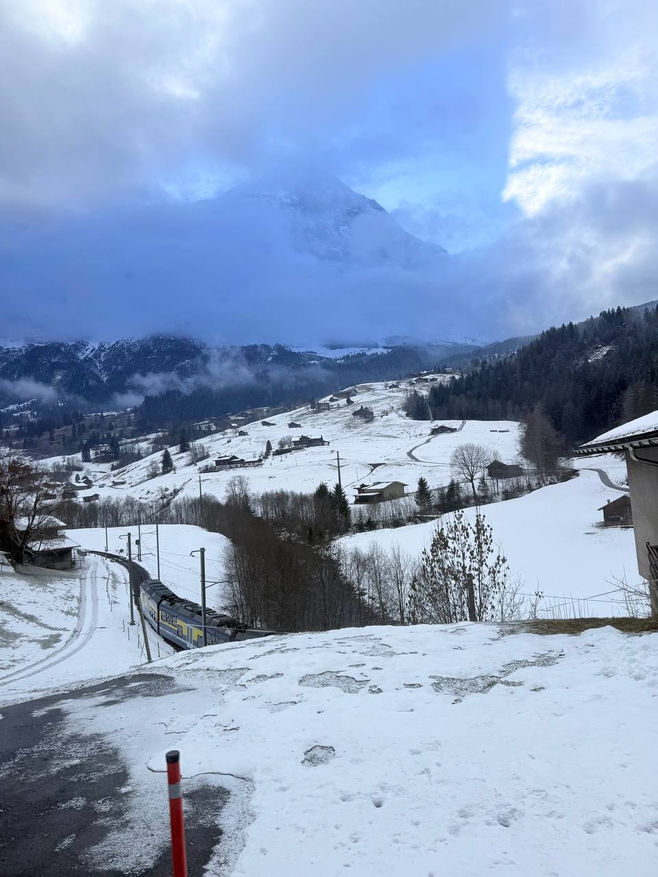 A train crossing a snowy mountain village
